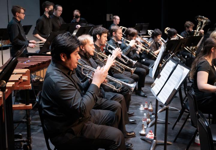 Students playing trumpets in a concert