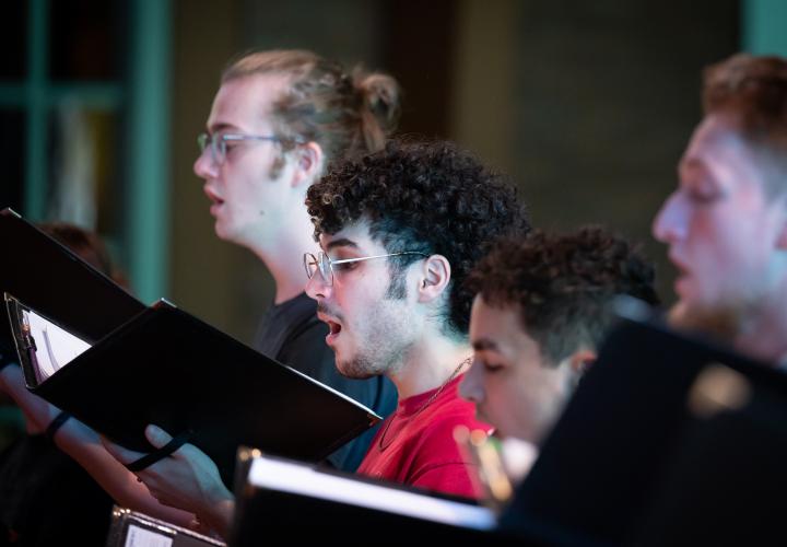 Close up of PSU choir students singing.