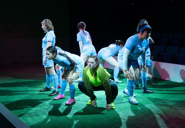 Actors frozen in soccer poses for PSU Theater's "The Wolves"