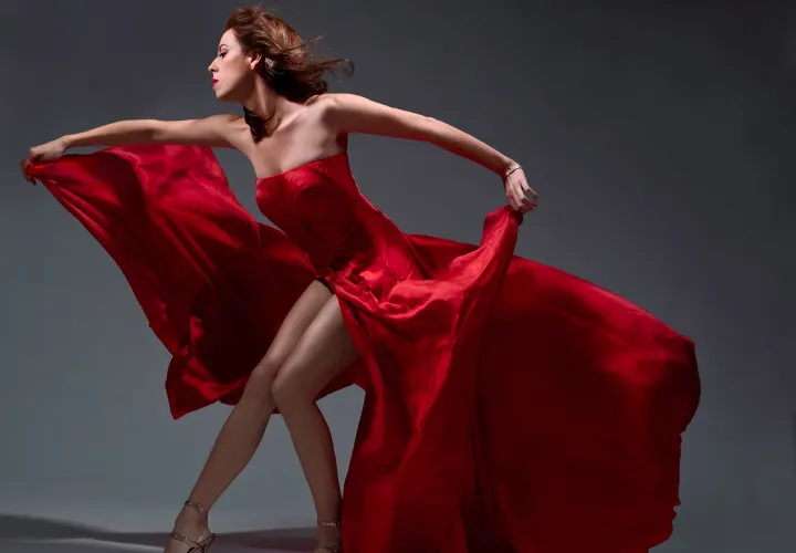 Opera singer and PSU alum Audrey Luna posing in a flowing red dress.