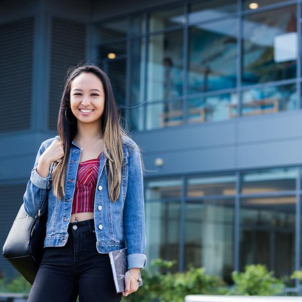 PSU Online student standing in front Recreation Center
