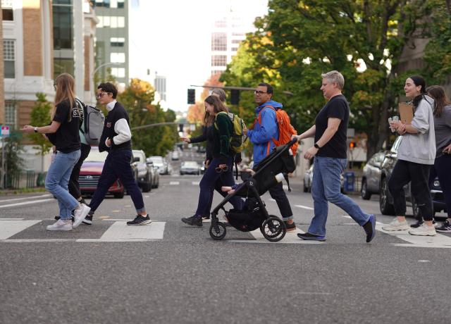 Group of people walking across a crosswalk
