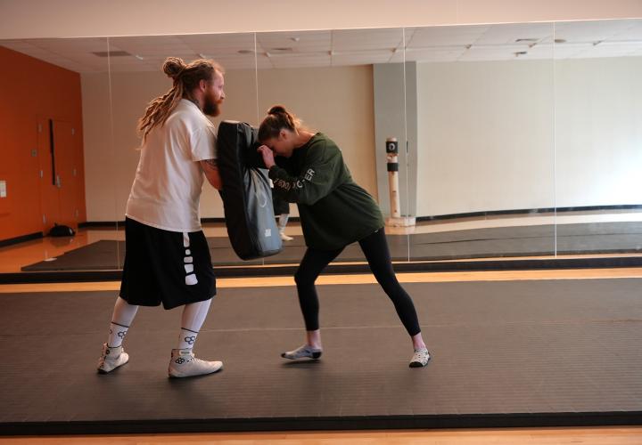 person teaching a self defense move