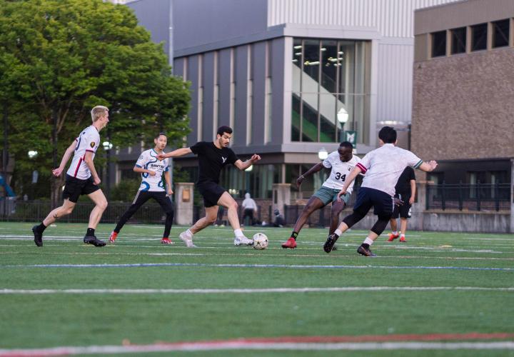 6 people playing outdoor soccer