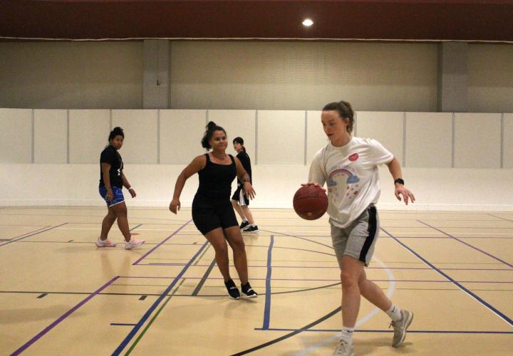 Women playing basketball