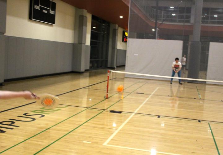 2 people playing pickleball