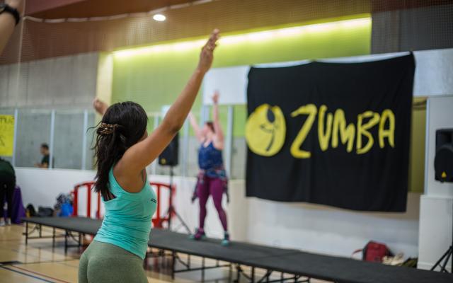 Participant following along with instructor's Zumba