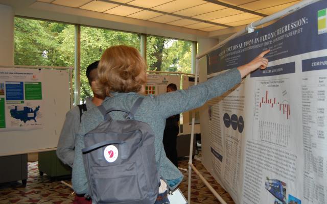 A student points to a research poster