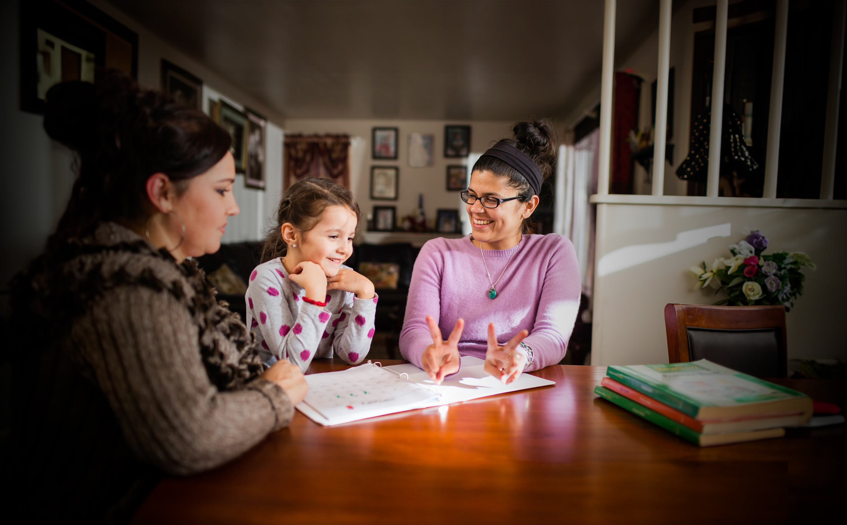 Teacher working with child and parent