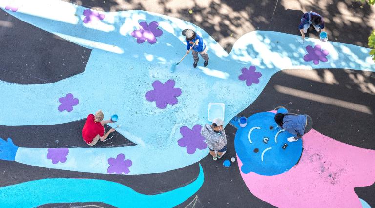 Students painting a street mural