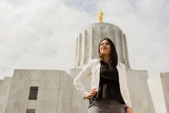 Woman standing on the steps of the Oregon state capitol building
