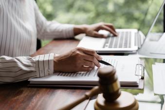 Student reading legal briefs at a computer