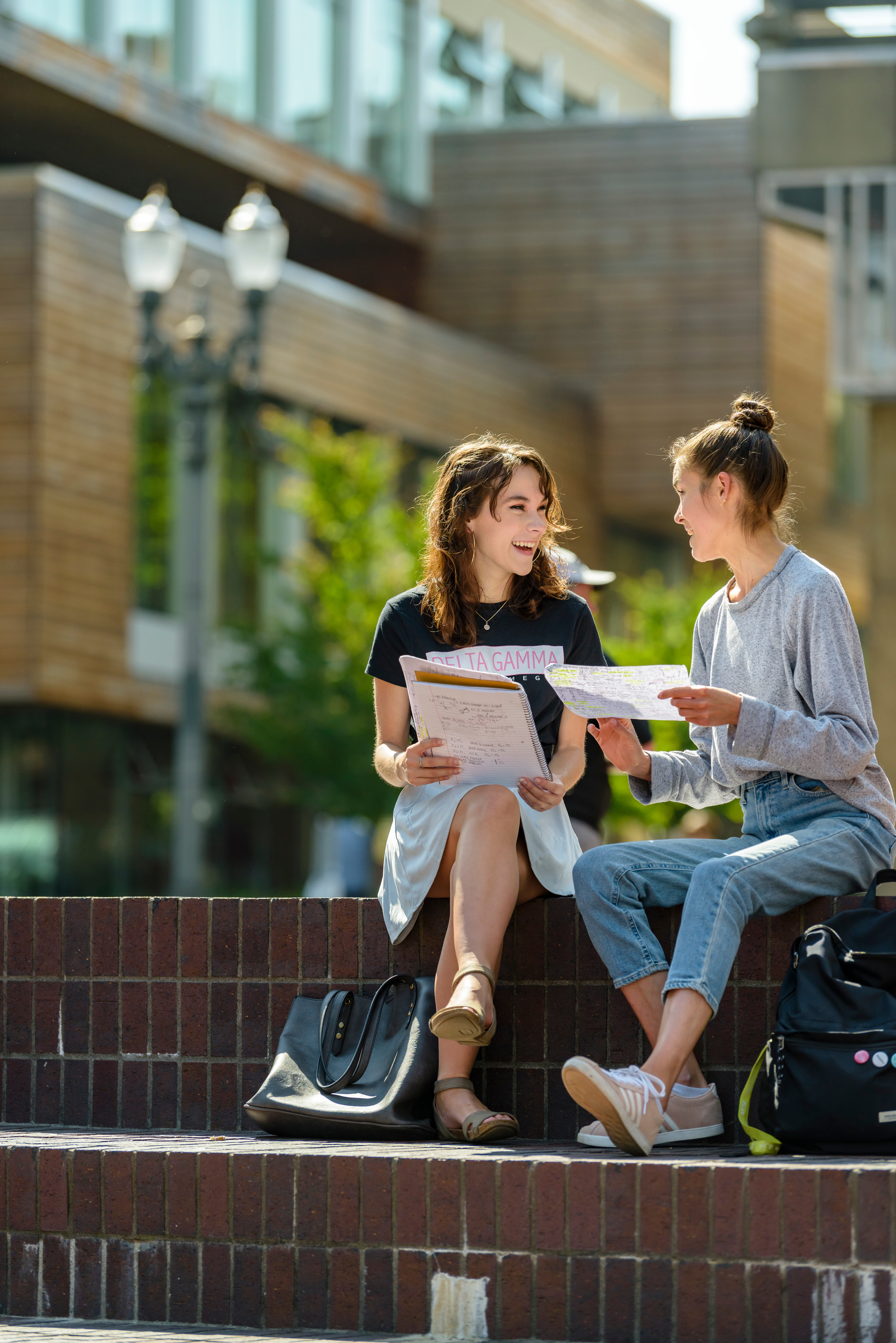 A tutor and a student sitting on steps in montgomery plaza