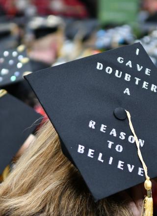 Back of head photo of a students wearing a mortar board on graduation day.