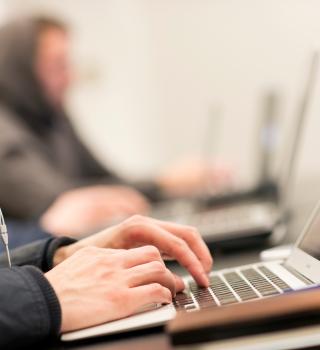 hands typing on keyboard 