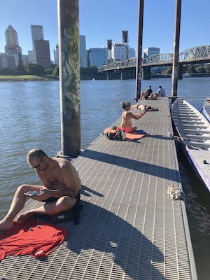 people sunbathing on a dock