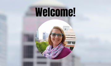 A circular photo of Norene Hough in the foreground with the word "Welcome!" above it and a blurred photo of a couple of Portland buildings in the background