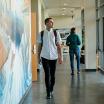 Student walking through the hall in the School of Social Work